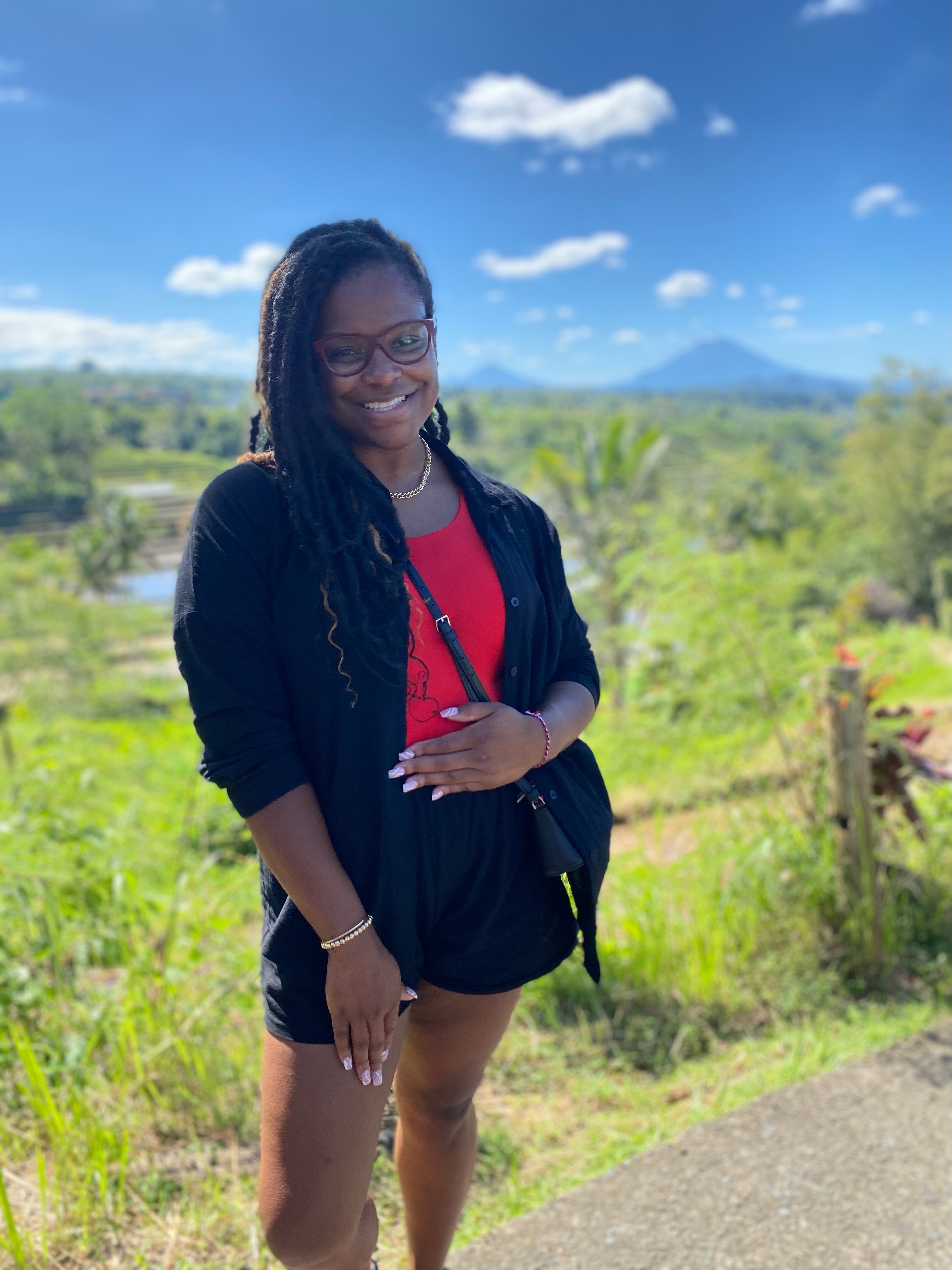 Jasmine Sheppard, founder of Twin Bloom Honeymoon Planning, smiling in the rice terraces of Bali